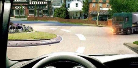 Is a bus driver obliged to give way to a truck at an intersection with roundabout traffic?