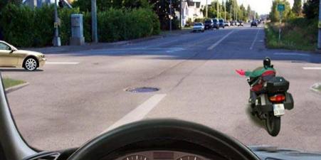 What does the motorcycle driver's hand signal tell you about?
