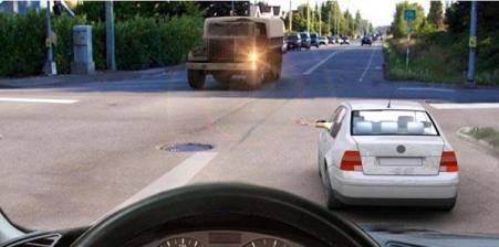 What does the car driver's hand signal tell you about?